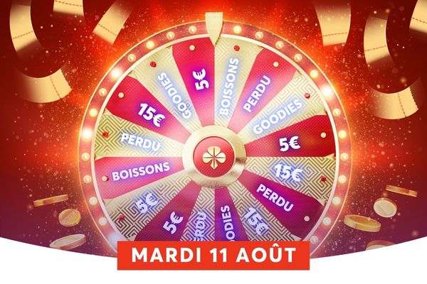 Une roue de la chance lumineuse tr�ne au centre de l'image, dor�e et divis�e en sections roses et magenta o� l'on devine des lots comme 